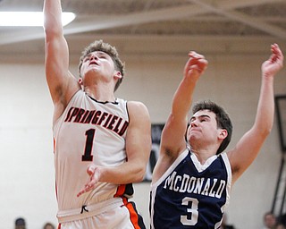 Springfield's Evan Ohlin tries to get a basket while McDonald's Parker Higgins tries to block him during their game at Springfield on Friday night. EMILY MATTHEWS | THE VINDICATOR