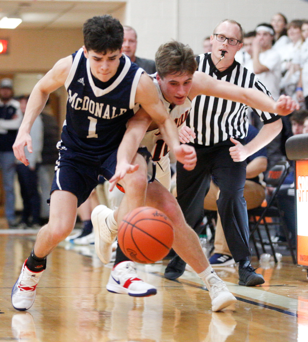 McDonald's Zach Rasile and Springfield's Clay Medvec go after the ball during their game at Springfield on Friday night. EMILY MATTHEWS | THE VINDICATOR