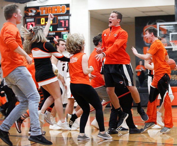 Springfield's student section rushes onto the court and celebrates after Springfield beat McDonald 87-71 on Friday night at Springfield High School. EMILY MATTHEWS | THE VINDICATOR