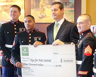 Allen Ryan, director of corporate affairs for Covelli Enterprises, presented a $15,000 check to the Marine Corps Toys for Tots program Friday. Accepting the check were, from left, staff Sgt. Jeremy Lehman, Sgt. Gregory Peterkin, Sgt. Wyman Wedding and staff Sgt. Mitchell Thompson.