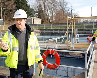 Communications consultant Jeff La Rue, left, and production manager George Ginnis discuss settling basins, which will be replaced by tanks, at the Aqua Ohio water treatment plant in Poland on Friday afternoon. 