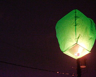 A lantern, which was lit and let go by Djuan Kimbrough, of Youngstown, and his family, floats off in honor of the five children who died in a house fire last week after their vigil outside Christ Centered Church on Saturday evening. EMILY MATTHEWS | THE VINDICATOR