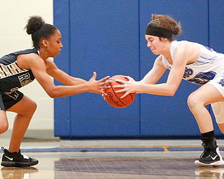 Warren's Diamond Phillips and Poland's Marlie McConnell go after the ball during their game at Poland Seminary High School on Saturday afternoon. EMILY MATTHEWS | THE VINDICATOR