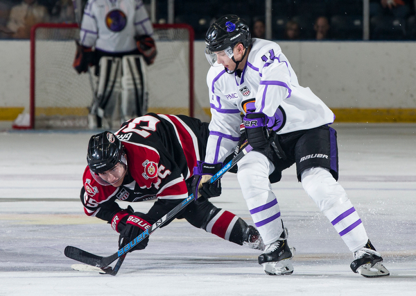 Scott R. Galvin | The Vindicator.Youngstown Phantoms defenseman Thomas Farrell (11) battles with Chicago Steel forward Josh Groll (25) for the puck during the second period at the Covelli Centre on Saturday, Dec. 15, 2018.