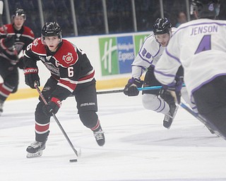 Chicago Steel's Nick Abruzzese takes the puck down the ice as the Phantoms' Josh DeLuca (26) and Nikolai Jenson (4) head towards him during their game at Covelli Centre on Sunday night. EMILY MATTHEWS | THE VINDICATOR