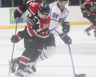 The Phantoms' Josh DeLuca tries to get the puck away from Chicago Steel's Nick Abruzzese during their game at Covelli Centre on Sunday night. EMILY MATTHEWS | THE VINDICATOR