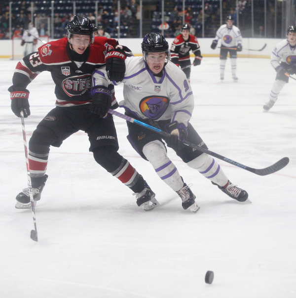 The Phantoms' Connor MacEachern and Chicago Steel's Jake Schmaltz go after the puck during their game at Covelli Centre on Sunday night. EMILY MATTHEWS | THE VINDICATOR