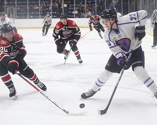 Chicago Steel's Uula Ruikka gets the puck away from Phantoms' Matthew Barnaby Jr. during their game at Covelli Centre on Sunday night. EMILY MATTHEWS | THE VINDICATOR