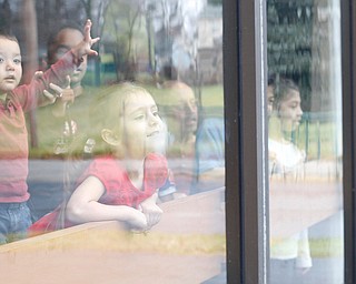 Mayson Hood, 2, left, and Abby Mannion, 4, both of Campbell, look out the window with other kids as they wait for Santa to arrive during Campbell's annual Lunch with Santa at St. Lucy Palermo Hall on Sunday afternoon. EMILY MATTHEWS | THE VINDICATOR