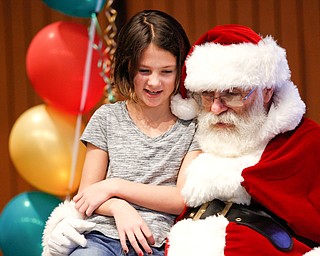 Tallah Hlebovy, 9, of Salem, tells Santa what she wants for Christmas during Campbell's annual Lunch with Santa at St. Lucy Palermo Hall on Sunday afternoon. EMILY MATTHEWS | THE VINDICATOR