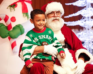 Dennis Williams, 6, of Campbell, gets his photo taken with Santa during Campbell's annual Lunch with Santa at St. Lucy Palermo Hall on Sunday afternoon. EMILY MATTHEWS | THE VINDICATOR