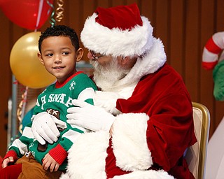 Dennis Williams, 6, of Campbell, tells Santa what he wants for Christmas during Campbell's annual Lunch with Santa at St. Lucy Palermo Hall on Sunday afternoon. EMILY MATTHEWS | THE VINDICATOR