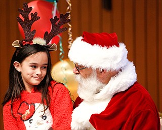 Bianca Rodriquez, 8, of Campbell, tells Santa what she wants for Christmas during Campbell's annual Lunch with Santa at St. Lucy Palermo Hall on Sunday afternoon. EMILY MATTHEWS | THE VINDICATOR