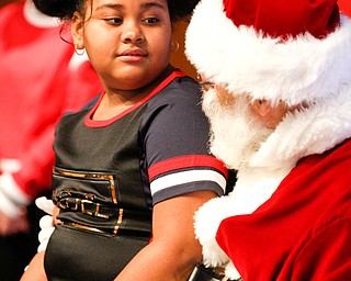 Dynasti Smith, 8, of Campbell, tells Santa what she wants for Christmas during Campbell's annual Lunch with Santa at St. Lucy Palermo Hall on Sunday afternoon. EMILY MATTHEWS | THE VINDICATOR