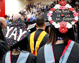Gina Marafiote, left, and Kristen Kukura wait to receive their diplomas for their Master of Science in Education for counseling during YSU's commencement ceremony in Beeghly Center on Sunday afternoon. EMILY MATTHEWS | THE VINDICATOR