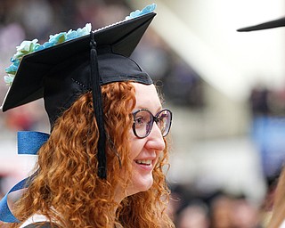 Tanya Silich waits in line to receive her diploma for her Master of Arts in Professional Communication during YSU's commencement ceremony in Beeghly Center on Sunday afternoon. EMILY MATTHEWS | THE VINDICATOR