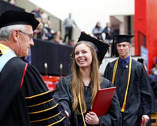 Logan Mitchell shakes hands with YSU President Jim Tressel after receiving her diploma for her Bachelor of Science in Business Administration during YSU's commencement ceremony in Beeghly Center on Sunday afternoon. EMILY MATTHEWS | THE VINDICATOR
