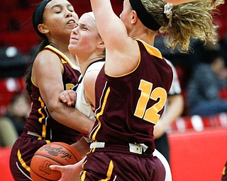 Struthers' Emma Elia tries to go toward the hoop while South Range's Lexi Giles, left, and Bree Kohler try to block her during their game at Struthers on Monday night. EMILY MATTHEWS | THE VINDICATOR