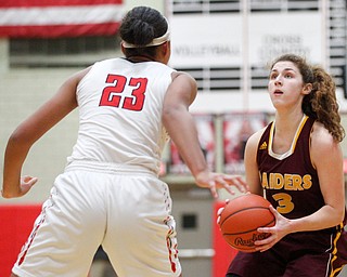 South Range's Izzy Lamparty looks to the hoop while Struthers' Trinity McDowell tries to block her during their game at Struthers on Monday night. EMILY MATTHEWS | THE VINDICATOR