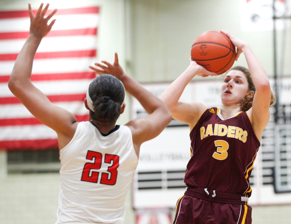 South Range's Izzy Lamparty shoots towards the hoop while Struthers' Trinity McDowell tries to block her during their game at Struthers on Monday night. EMILY MATTHEWS | THE VINDICATOR