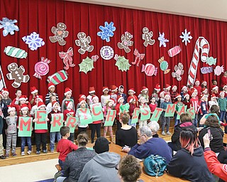 Austintown Elementary first-grade students put on a Christmas concert Monday with carols, signs and dancing.