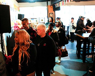 People wait inside Flambeau's Live to buy a pasta dinner during a fundraiser to raise money for the funeral of the five fire victims on Tuesday evening. EMILY MATTHEWS | THE VINDICATOR