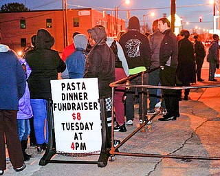 People wait in line outside of Flambeau's Live for a pasta dinner fundraiser for the funeral of the five fire victims on Tuesday evening. EMILY MATTHEWS | THE VINDICATOR