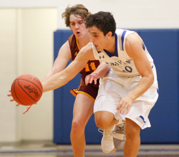 Poland's Adam Kassem dribbles the ball down the court with South Range's Dante DiGaetano close behind him during their game at Poland on Tuesday night. EMILY MATTHEWS | THE VINDICATOR