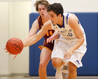 Poland's Adam Kassem dribbles the ball down the court with South Range's Dante DiGaetano close behind him during their game at Poland on Tuesday night. EMILY MATTHEWS | THE VINDICATOR