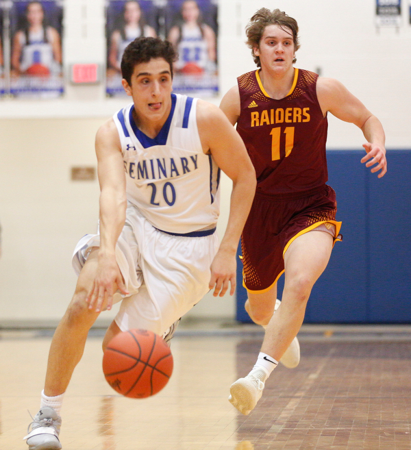 Poland's Adam Kassem dribbles the ball down the court with South Range's Dante DiGaetano close behind him during their game at Poland on Tuesday night. EMILY MATTHEWS | THE VINDICATOR