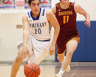 Poland's Adam Kassem dribbles the ball down the court with South Range's Dante DiGaetano close behind him during their game at Poland on Tuesday night. EMILY MATTHEWS | THE VINDICATOR