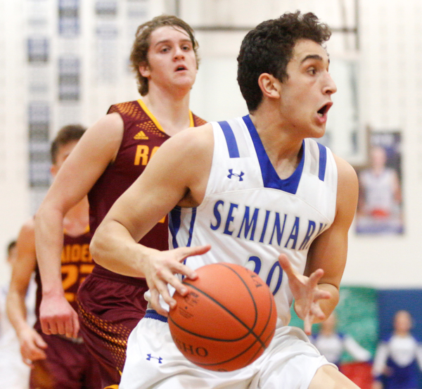 Poland's Adam Kassem dribbles the ball down the court with South Range's Dante DiGaetano close behind him during their game at Poland on Tuesday night. EMILY MATTHEWS | THE VINDICATOR