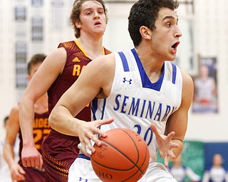 Poland's Adam Kassem dribbles the ball down the court with South Range's Dante DiGaetano close behind him during their game at Poland on Tuesday night. EMILY MATTHEWS | THE VINDICATOR