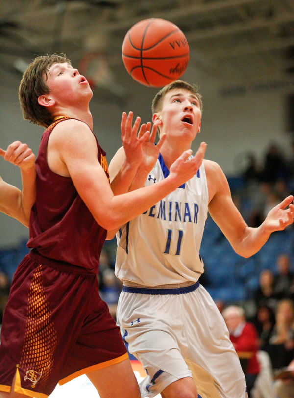 South Range's Chris Brooks and Poland's Collin Todd try to catch a rebound during their game at Poland on Tuesday night. EMILY MATTHEWS | THE VINDICATOR