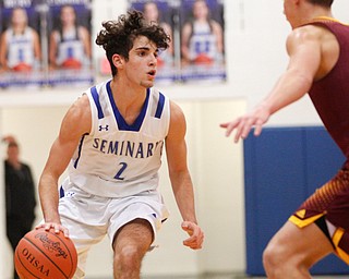 Poland's Andrew Centofanti looks to pass the ball while South Range's Nick Matos tries to block him during their game at Poland on Tuesday night. EMILY MATTHEWS | THE VINDICATOR