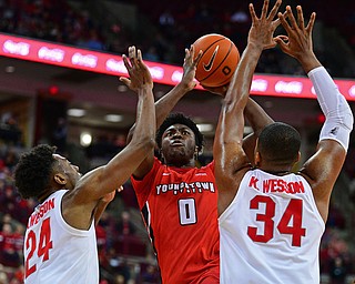 COLUMBUS, OHIO - DECEMBER 18, 2018: Youngstown State's Antwan Maxwell Jr. puts up a shot over Ohio State's Andre Wesson, left, and Kaleb Wesson during the second half of their game, Tuesday night at the Schottenstein Center. Ohio State won 75-56. DAVID DERMER | THE VINDICATOR