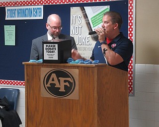 Neighbors | Jessica Harker .President of Man Up Mahoning Valley Paul Homick and event organizer and cancer survivor Steve Burbrink spoke to students at Austintown High School's first Shave Off event on Nov. 29.