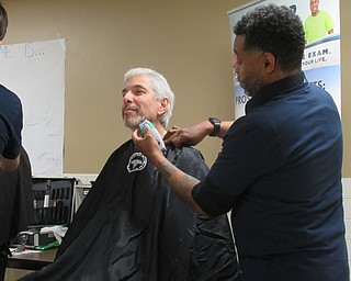 Neighbors | Jessica Harker .Phil Pillin, a cancer survivor and member of Man Up Mahoning Valley, participated in the Shave Off event at Austintown High School on Nov. 29 where barbers from Excalibur Barbers shaved 27 men to bring awareness to prostate cancer.