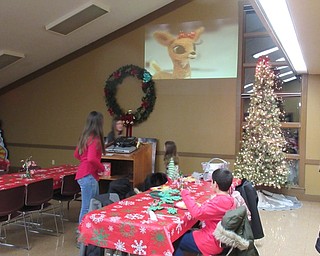 Neighbors | Jessica Harker.Community members ate dinner and watched "Rudolph the Red Nosed Reindeer" on Dec. 6 at Boardman Park's Supper with Santa event.