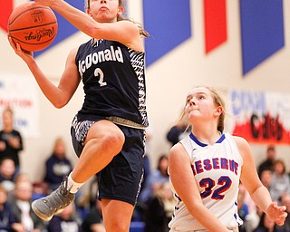 McDonald's Olivia Perry jumps to make a shot while Western Reserve's Alyssa Serensky tries to block during their game at Western Reserve on Thursday night. EMILY MATTHEWS | THE VINDICATOR