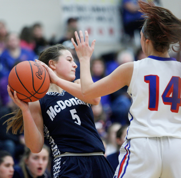 McDonald's Lucy Wolford looks to pass the ball while Western Reserve's Kennedy Miller tries to block her during their game at Western Reserve on Thursday night. EMILY MATTHEWS | THE VINDICATOR