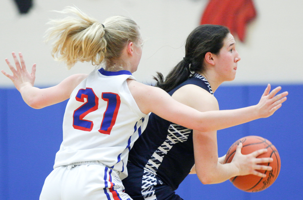 McDonald's Sophia Costantino looks to pass the ball while Western Reserve's Olivia Pater tries to block her during their game at Western Reserve on Thursday night. EMILY MATTHEWS | THE VINDICATOR