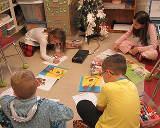 Neighbors | Jessica Harker.Students read holiday themed books in centers on Dec. 14 during Poland Elementary School's pajama day.