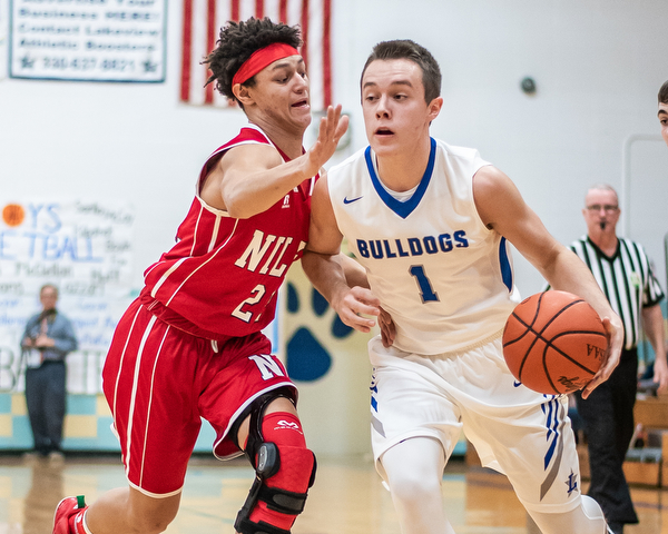 DIANNA OATRIDGE | THE VINDICATOR Lakeview's Daniel Evans(1) drives against Niles' Corbin Foy (22) during the Bulldogs' 68-41 victory in Cortland on Friday.