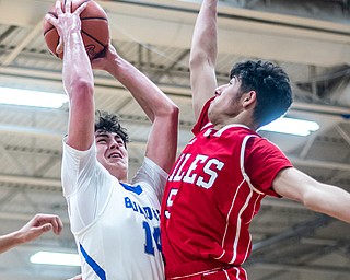 DIANNA OATRIDGE | THE VINDICATOR Niles' Lakeview's Brendon Kilpatrick (14) drives to the hoop against Niles' Vincent Chieffo (5) during the Bulldogs' 68-41 victory in Cortland on Friday.