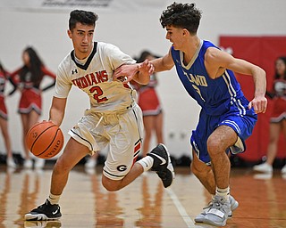 GIRARD, OHIO - DECEMBER 21, 2018: Girard's Austin Claussell drives on Poland's Andrew Centofanti during the first half of their game, Friday night at Girard High School. DAVID DERMER | THE VINDICATOR