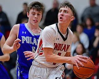 GIRARD, OHIO - DECEMBER 21, 2018: Girard's Adam Connelly goes to the basket after getting past Poland's Jeff McAuley during the first half of their game, Friday night at Girard High School. DAVID DERMER | THE VINDICATOR