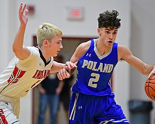 GIRARD, OHIO - DECEMBER 21, 2018: Poland's Andrew Centofanti drives while being pressured by Girard's Nick Bonamase during the second half of their game, Friday night at Girard High School. DAVID DERMER | THE VINDICATOR