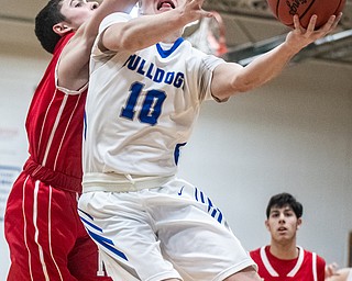 DIANNA OATRIDGE | THE VINDICATOR Lakeview's AJ McClellan (10) drives to the hoop against pressure from Niles' Doug Foster (2) defends during the Bulldogs' 68-41 victory in Cortland on Friday.
