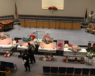      ROBERT  K. YOSAY | THE VINDICATOR.. Services for the five children killed Dec. 9 in a fire at their Parkcliffe Avenue home were held at New Bethel Baptist Church...A person pays his respects to the 5 children